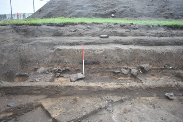 Stepped trench section showing the depth of midden deposits overlying the archaeological features Stepped trench section showing the depth of midden deposits overlying the archaeological features