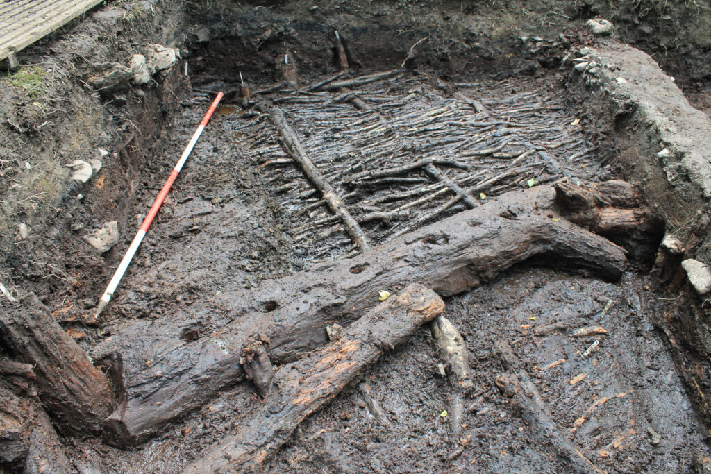 A sill beam shaped around posts at either end, with the wickerwork sub-floor layer showing in the background A sill beam shaped around posts at either end, with the wickerwork sub-floor layer showing in the background