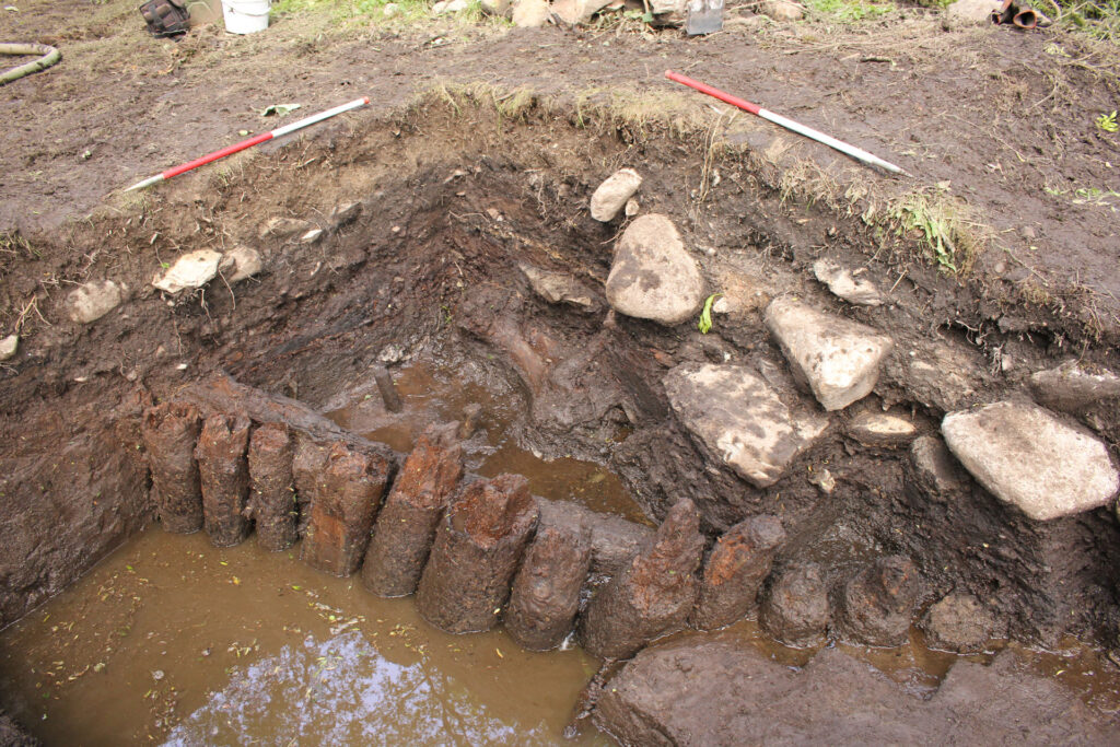 Section through roundhouse ST4 showing hearths 1 and 2 with the Episode 1 palisade in front Section through roundhouse ST4 showing hearths 1 and 2 with the Episode 1 palisade in front