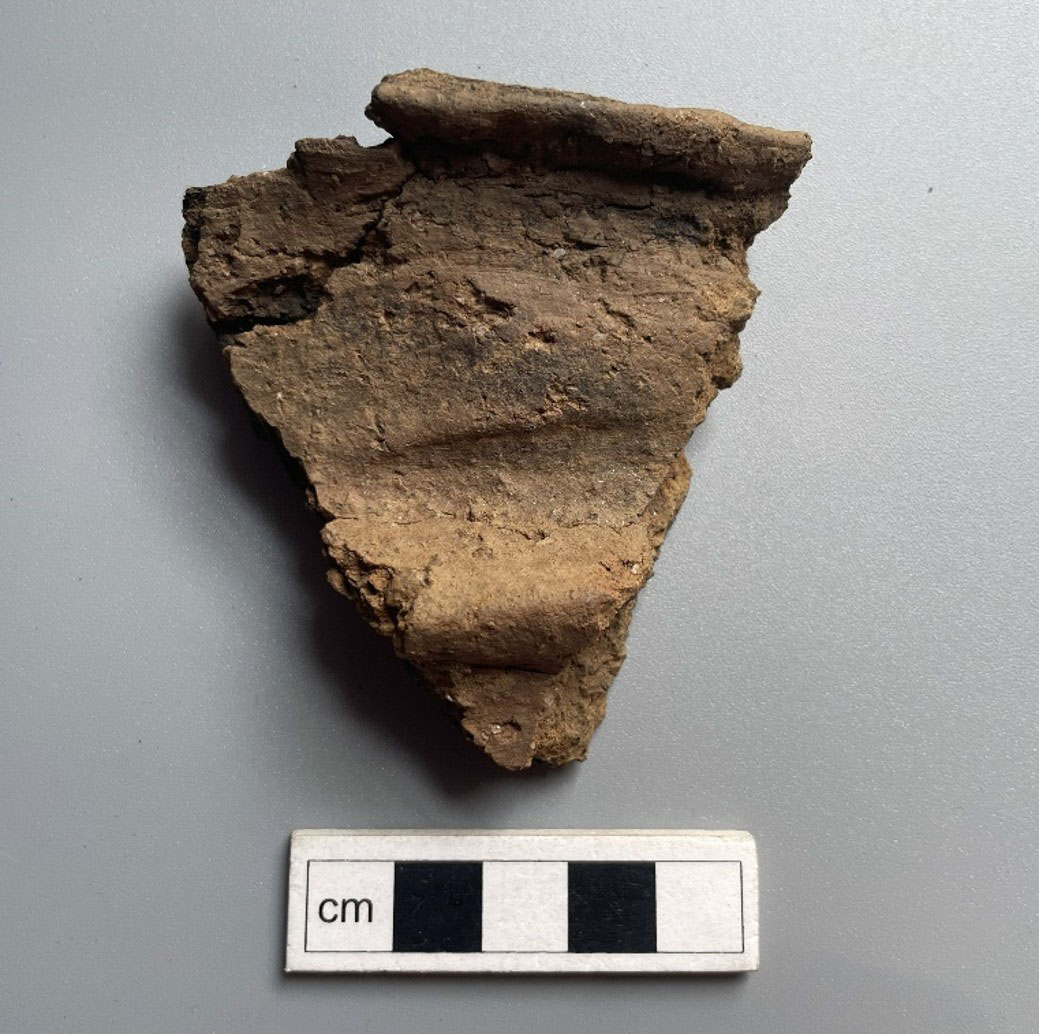 Neolithic pottery fragment with rim and lug