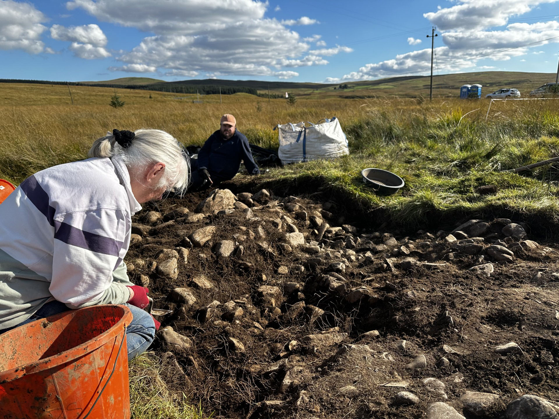 Community volunteers excavating the cairn